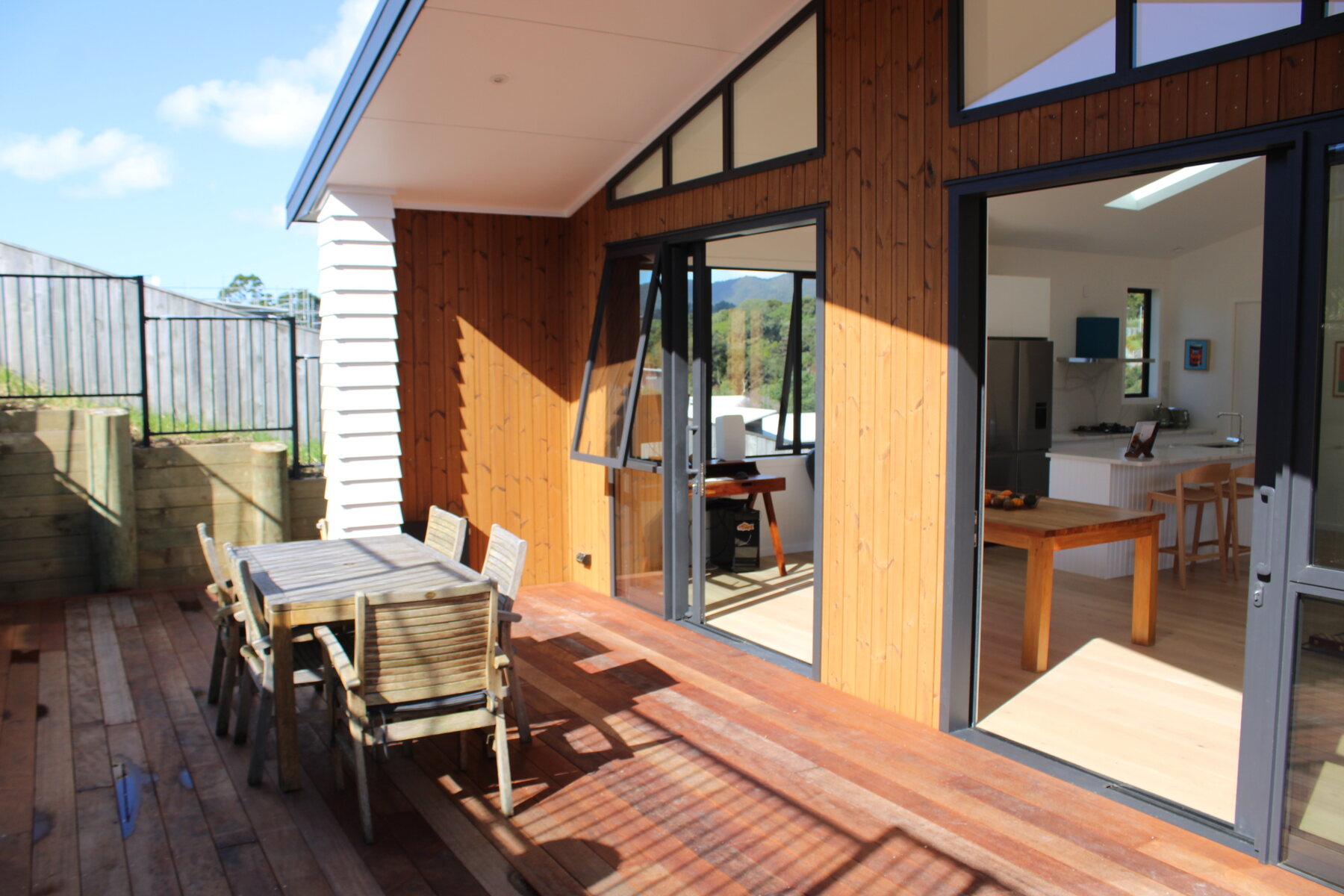 Deck with table, chairs, and sliding doors into the living room